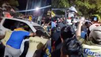 Aficionados de América mueven camioneta de la Guardia Nacional durante los festejos del bicampeonato