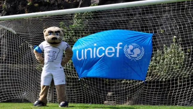 Goyo posa con la bandera de la Unicef | PUMAS.MX