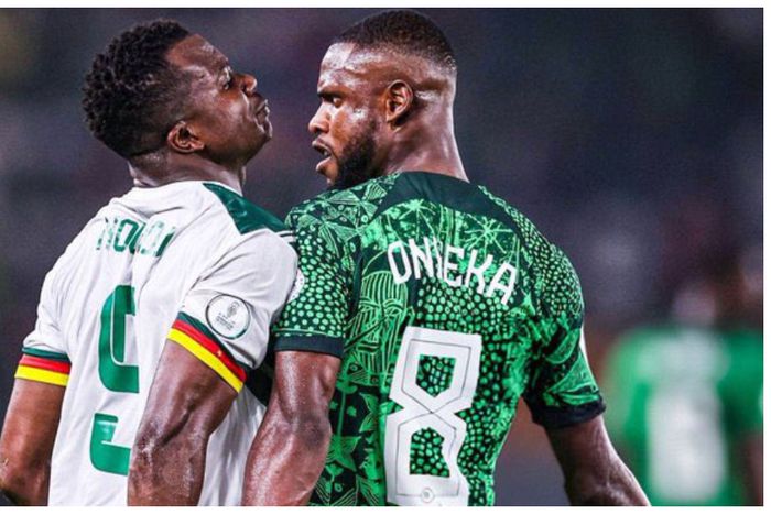 Frank Onyeka tackles a Cameroonian during the game.