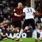 Manchester City's Erling Haaland is challenged by Fulham's players.