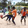 Football players in action during the Kenya Beach Games