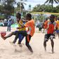 Football players in action during the Kenya Beach Games