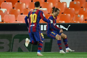 Messi double leads Barca to nail-biting win over Valencia
