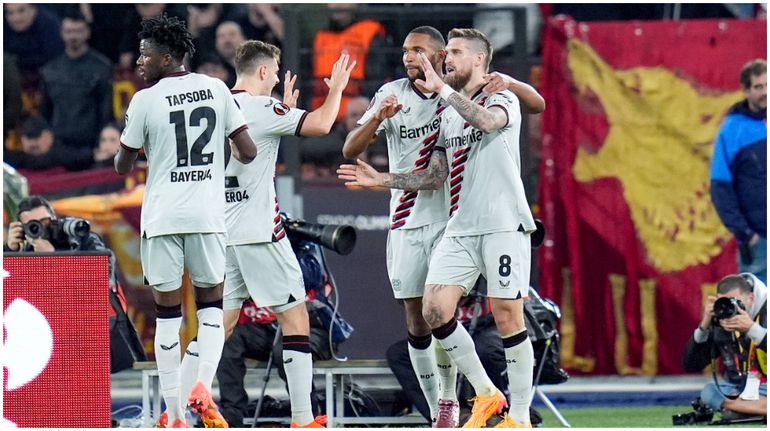 Bayer Leverkusen players celebrate Robert Andrich's remarkable winner.