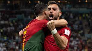 Bruno Fernandes and Cristiano Ronaldo celebrating a goal for Portugal