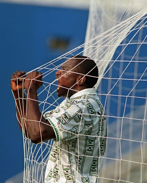 Super Eagles celebrate legend Rashidi Yekini for Nigeria's 1st World Cup goal, showing off tears and holding the net.