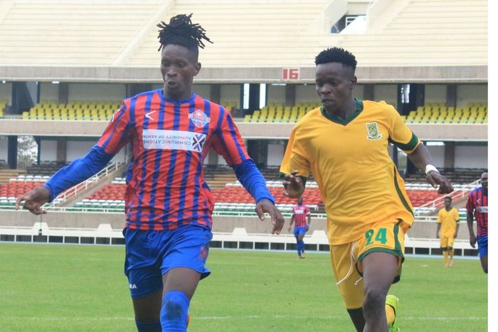 Francis Kahiro and Mathare player tussle for the ball