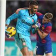 Barcelona's Ferran Torres fights Girona's goalkeeper for the ball.