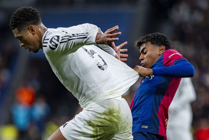 Jude Bellingham of Real Madrid CF (L) seen in action defended by Lamine Yamal of FC Barcelona (R)  || Image credit: Imago