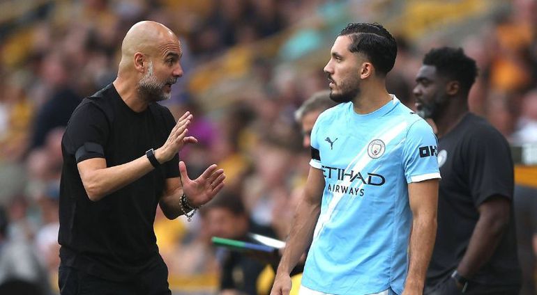 Pep Guardiola in a conversation with Rayan Cherki || Image credit: Imago