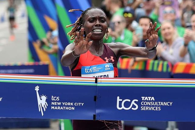 Sharon Lokedi cuts the tape at the 2022 New York City Marathon