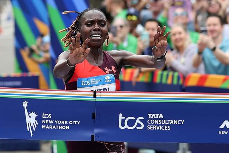 Sharon Lokedi cuts the tape at the 2022 New York City Marathon