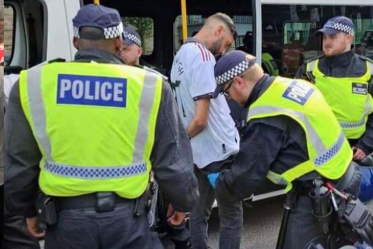 A fan being arrested for wearing an offensive shirt during 2023 FA Cup final.