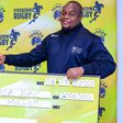 Tusker Brand Manager Lennox Mwalea (L) and Driftwood Sevens Tournament Director Kevin Wambura (R) during the check handover