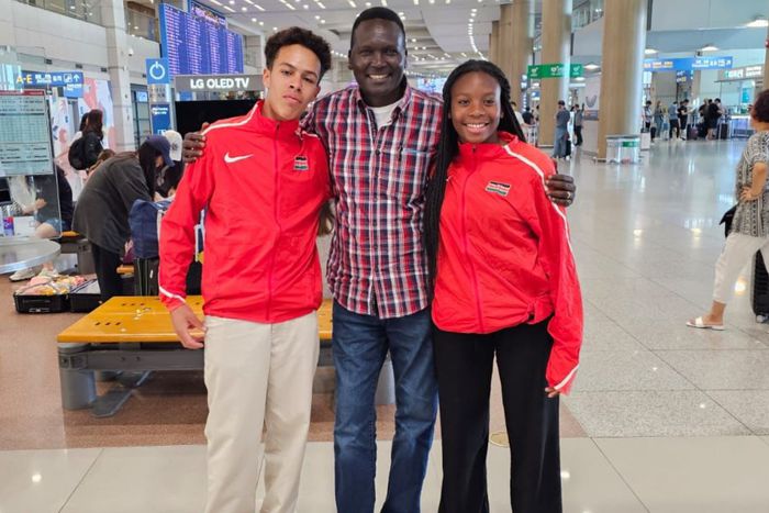 Ashley Tshanda, a Cross Country Skier and Issa Laborde, an Alpine Skier pose for a photo with Paul Tergat