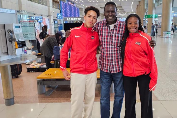 Ashley Tshanda, a Cross Country Skier and Issa Laborde, an Alpine Skier pose for a photo with Paul Tergat