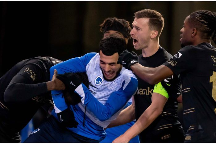 The Nigerian giants sandwiched by his teammates.