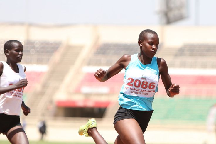 A junior athlete cuts the tape during a previous AK meet