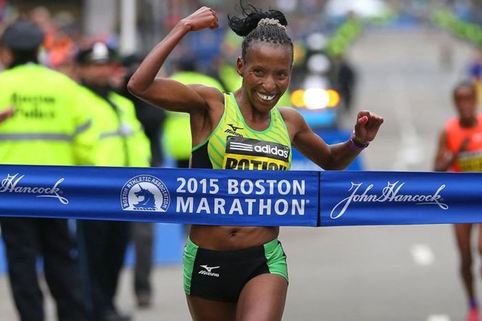 Caroline Rotich cuts the tape at the 2015 Boston Marathon