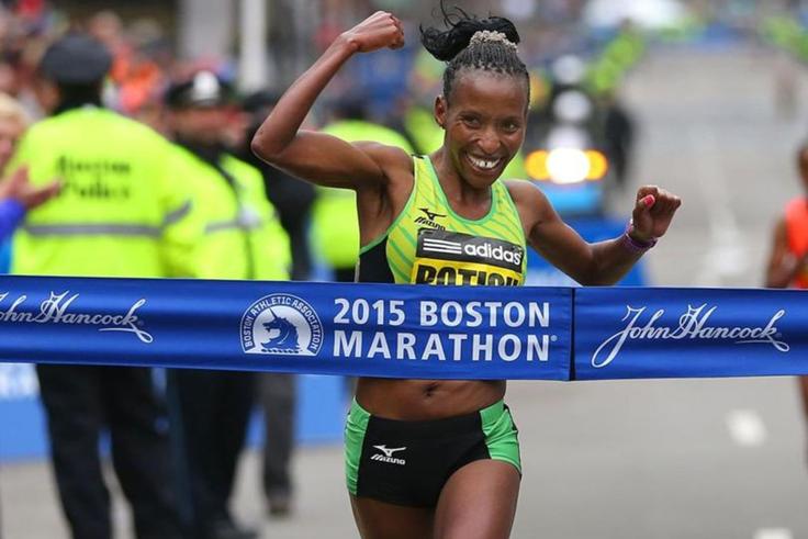 Caroline Rotich cuts the tape at the 2015 Boston Marathon