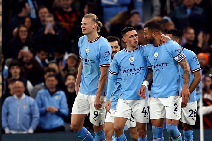 Kyle Walker, Phil Foden and Erling Haaland celebrate Manchester City goal.