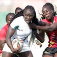 Kenya Lionesses Grace Adhiambo (left) battle with Uganda Juliet Coll during 23rd Edition of Safari 7s Rugby tournament on October 31 in 2010 at the Nyayo National Stadium.
