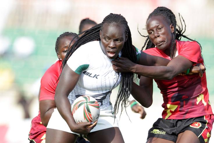 Kenya Lionesses Grace Adhiambo (left) battle with Uganda Juliet Coll during 23rd Edition of Safari 7s Rugby tournament on October 31 in 2010 at the Nyayo National Stadium.