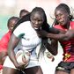 Kenya Lionesses Grace Adhiambo (left) battle with Uganda Juliet Coll during 23rd Edition of Safari 7s Rugby tournament on October 31 in 2010 at the Nyayo National Stadium.