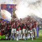 Serie A Alessio Romagnoli of AC Milan lifts the Scudetto trophy as players of AC Milan celebrate during during the award ceremony after the Serie A football match between US Sassuolo and AC Milan.
