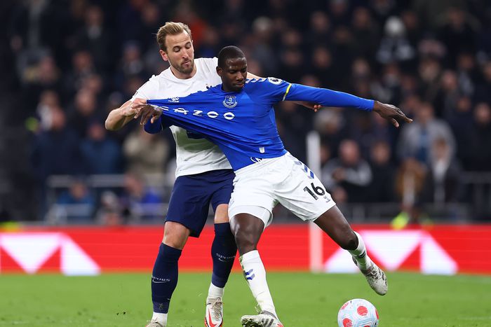 Harry Kane and Doucoure tussle for the ball