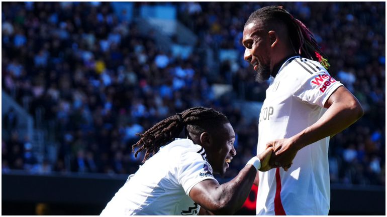 Calvin Bassey celebrates with Alex Iwobi after his milestone display for Fulham against Liverpool.