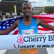 Kenyan-born Hillary Bor reacts to setting new American 10-mile record