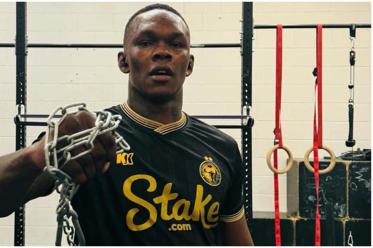 Nigerian-born UFC and MMA star Israel Adesanya models in Enyimba's iconic black kit.
