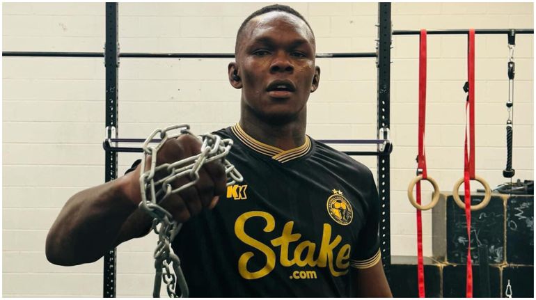 Nigerian-born UFC and MMA star Israel Adesanya models in Enyimba's iconic black kit.