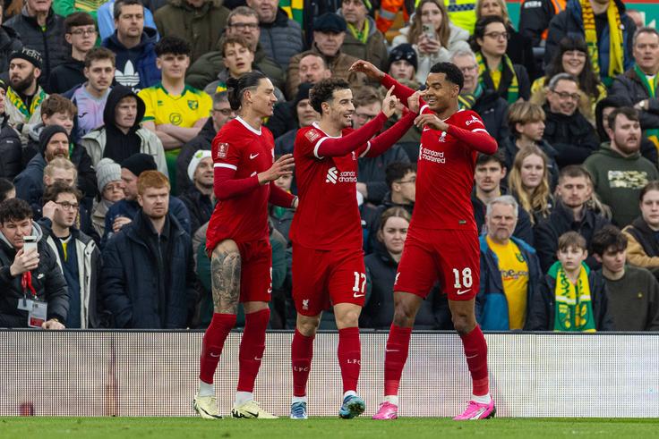 Liverpool s Curtis Jones (C) celebrates with team-mates Darwin Nunez (L) and Cody Gakpo (R) after scoring the first goal during the FA Cup 4th Round match between Liverpool FC and Norwich City FC at Anfield. (Photo by David Rawcliffe Propaganda)