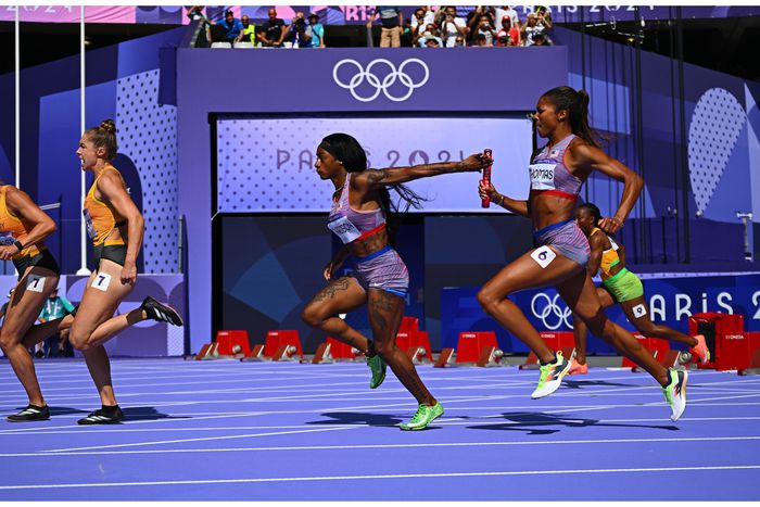 Sha'Carri Richardson and Gabby Thomas before the final lap in the relay heats.