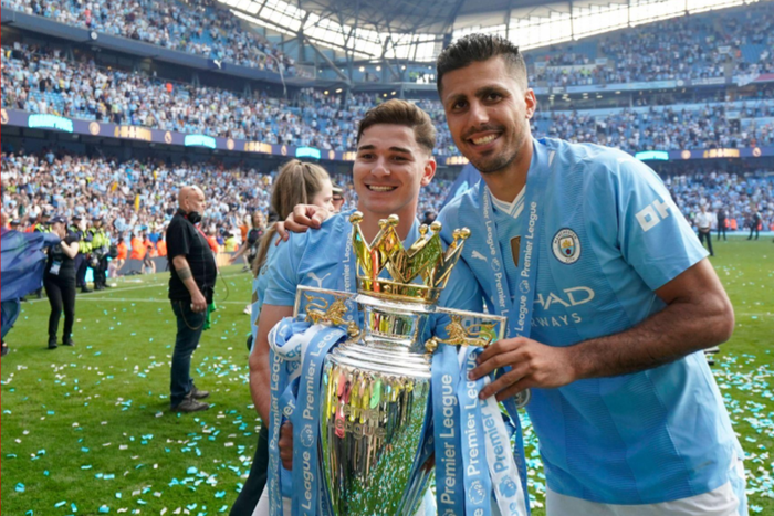 Rodri of Manchester City (R) and Julian Alvarez of Manchester City celebrate with the Premier league trophy during the Premier League match at the Etihad Stadium, Manchester. Picture credit: Andrew Yates / Sportimage