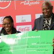 AK president Jack Tuwei receives cheque from Safaricom.