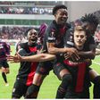 Bayer Leverkusen players including Nathan Tella and Victor Boniface celebrate after the Roma game.