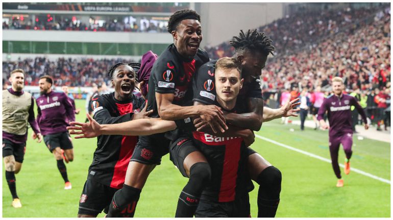 Bayer Leverkusen players including Nathan Tella and Victor Boniface celebrate after the Roma game.