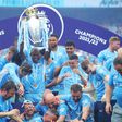 Manchester City players celebrate winning the 2021-2022 Premier League.