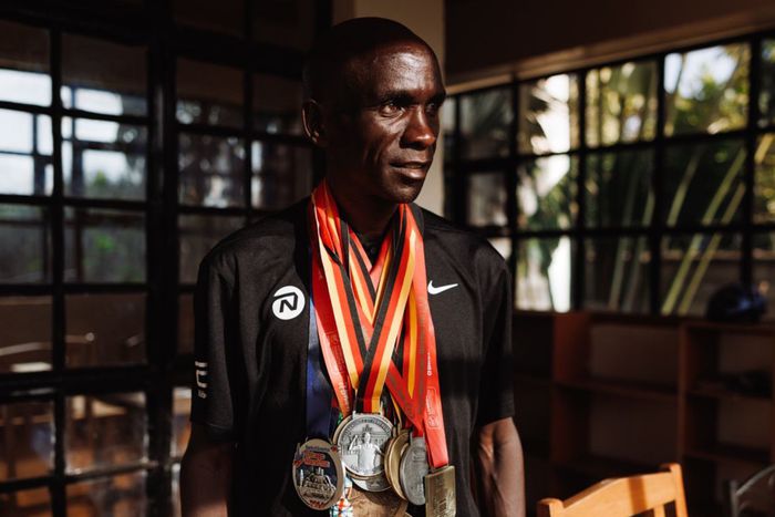 Eliud Kipchoge posing for a photo with his medals.