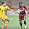 Al Faisaly forward Masud Juma dribbling past two players.