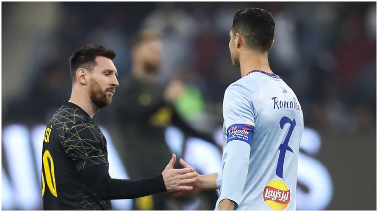 Lionel Messi (L) and Cristiano Ronaldo greet each other prior Riyadh All-Star XI vs Paris Saint-Germain FC at King Fahd Stadium.