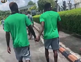 Ahead of the game between Nigeria and Libya, Super Eagles forward Victor Boniface and Taiwo Awoniyi hold hands.