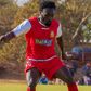Kenya Police forward Elvis Rupia controls the ball.