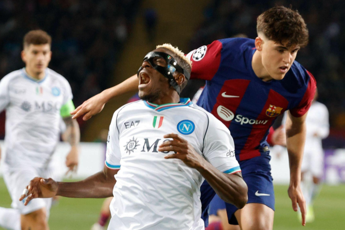 Victor Osimhen goes to ground after tackle from Pau Cubarsi in Barcelona vs Napoli || Image credit Imago
