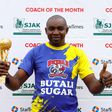 Butali Sugar Warriors Coach poses for a photo with his trophy