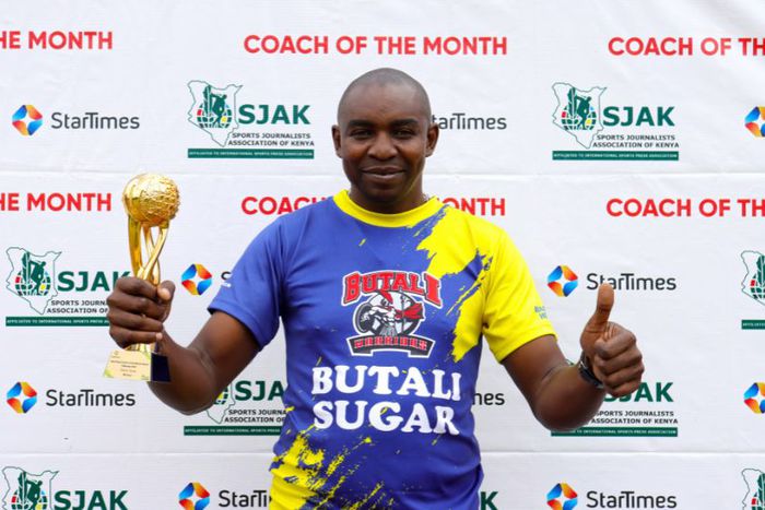 Butali Sugar Warriors Coach poses for a photo with his trophy