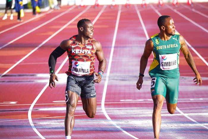 Ferdinand Omanyala at the finish line with Akani Simbine.